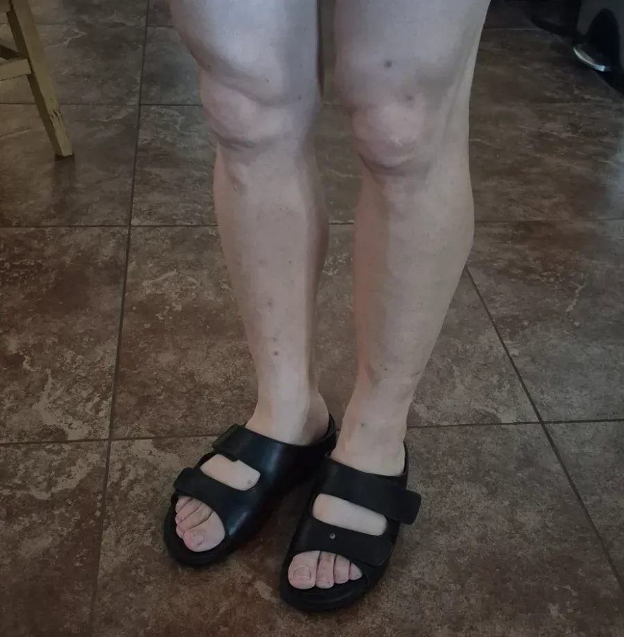 Standing in a pair of black JGP leather slippers on a tile floor