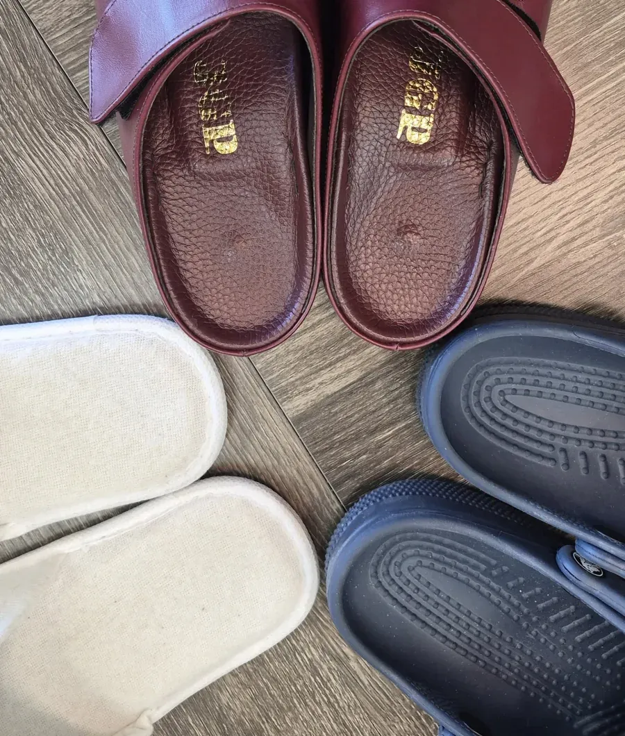 Burgundy JGP sandals beside other everyday footwear in Tucson